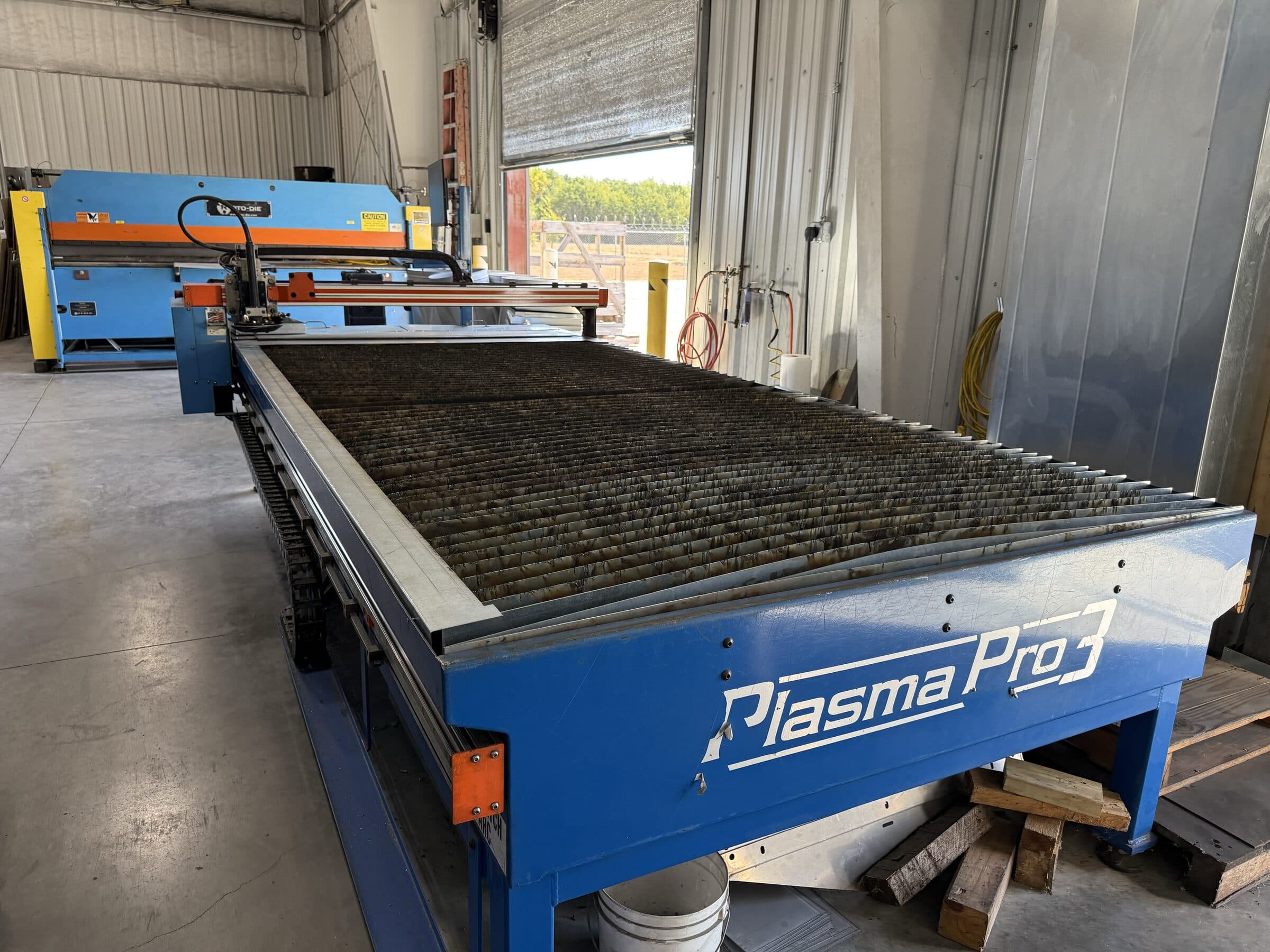 CNC plasma cutting table inside Seneca Mechanical's fabrication shop